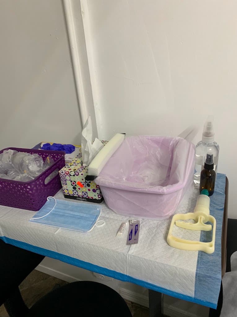 Sterile single-use hijama equipment laid out before a session in Flushing, Queens: individually wrapped cups, a new sealed blade, face mask, gloves, disposable couch covers and sanitiser
